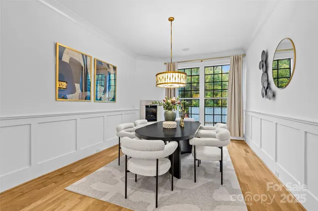 a view of staircase with lots of frames on wall and a window