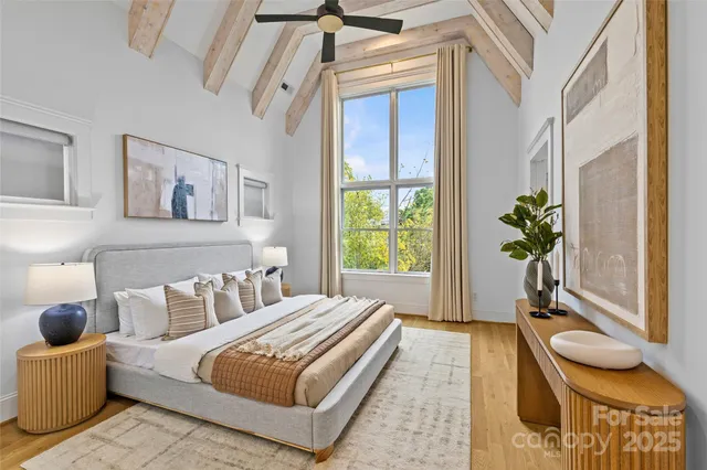 a bed sitting in a bedroom next to a window