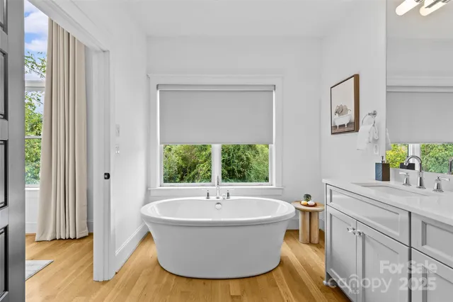 a view of a room with wooden floor and a window