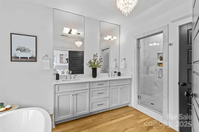 a bathroom with a sink a large mirror and shower