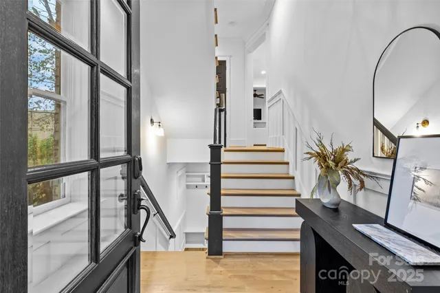 a view of entryway and hall with wooden floor