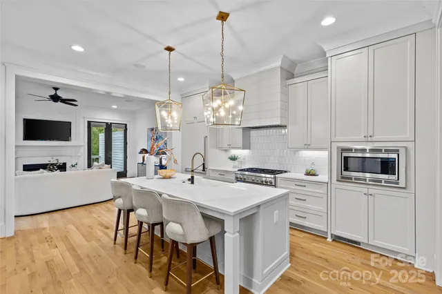 a living room with fireplace furniture and a large window