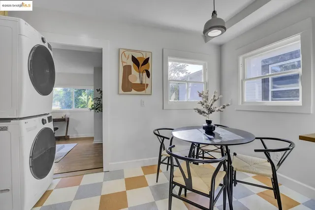 a kitchen with stainless steel appliances kitchen island granite countertop a dining table chairs and granite counter tops