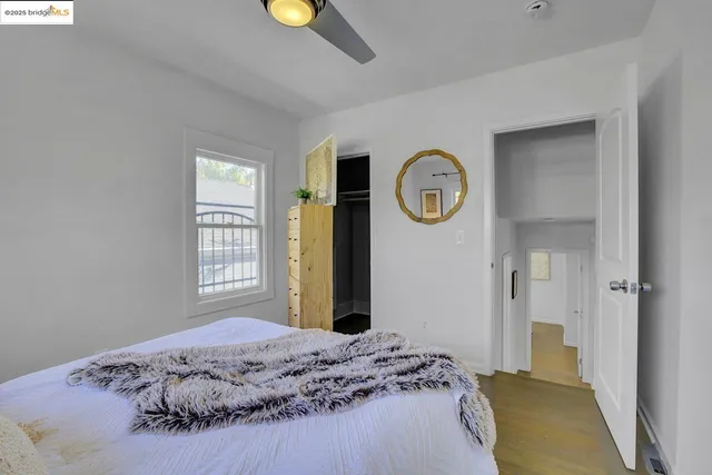 a bedroom with a bed and a window