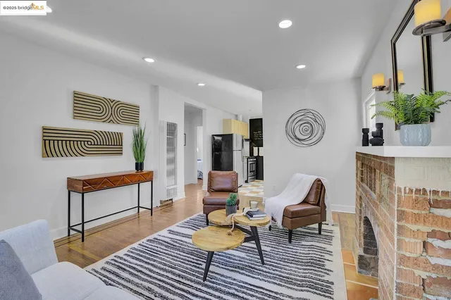 a living room with furniture a fireplace and a window