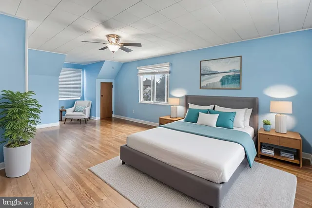 a spacious bedroom with a bed and a chandelier