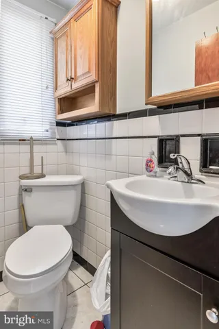 a bathroom with a toilet a sink and a window