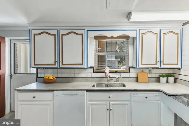 a kitchen with a sink and a window