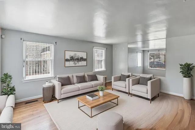 a living room with furniture and a large window