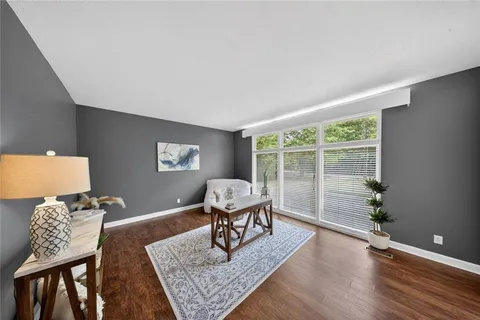 a living room with fireplace furniture and a large window