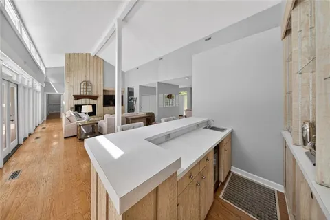 a kitchen with a sink appliances and cabinets
