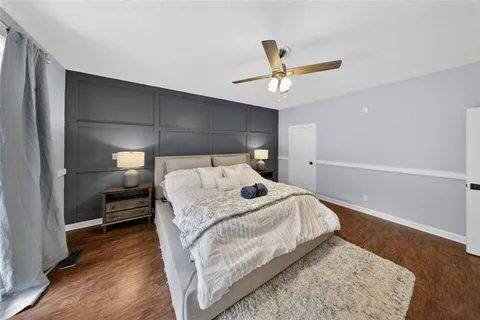 a bed sitting in a bedroom next to a window