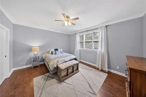 a room with gym equipment and wooden floor