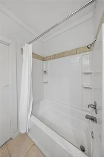 a view of a bathroom with a tub and shower