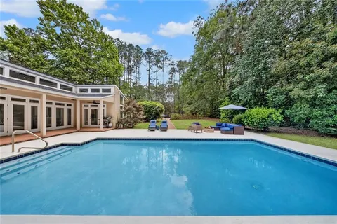 a view of a swimming pool with chairs