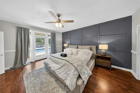 a living room with furniture a large window and chandelier