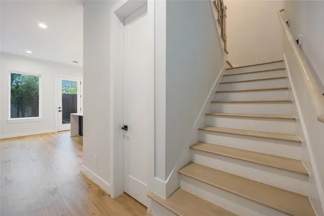 a view of entryway with wooden floor and stairs