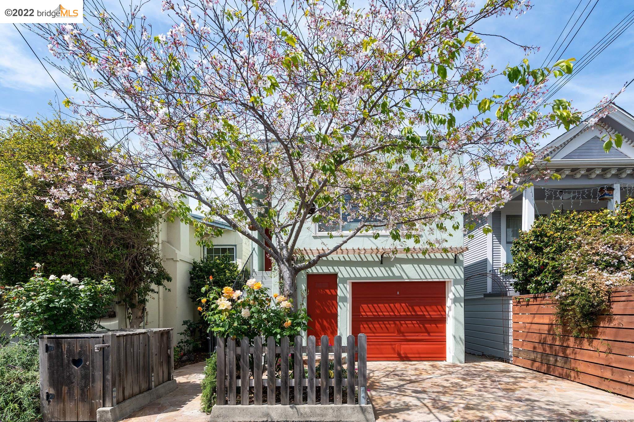 a front view of a house with a tree