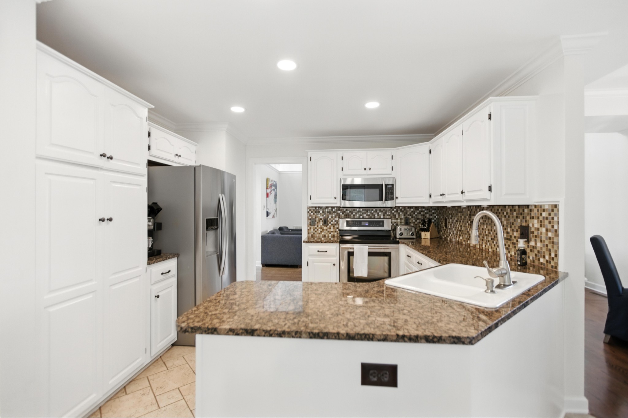208 Loop Drive Winchester, TN 37398 - Photo 24 of 88 a kitchen with stainless steel appliances granite countertop a sink refrigerator and cabinets