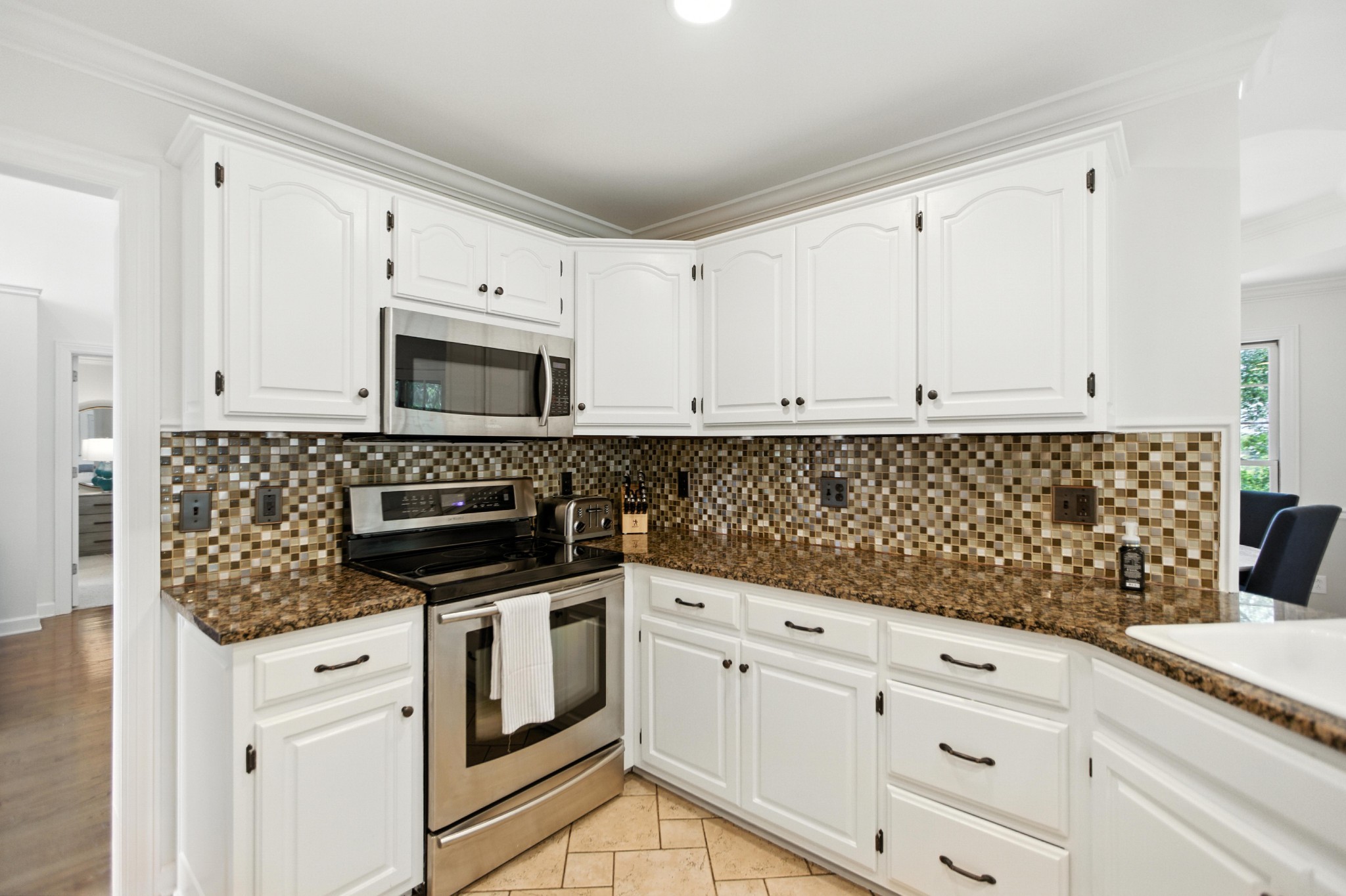 208 Loop Drive Winchester, TN 37398 - Photo 25 of 88 a kitchen with granite countertop white cabinets and white appliances