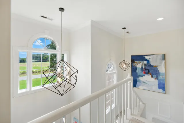 a view of a room that has a large window with front door