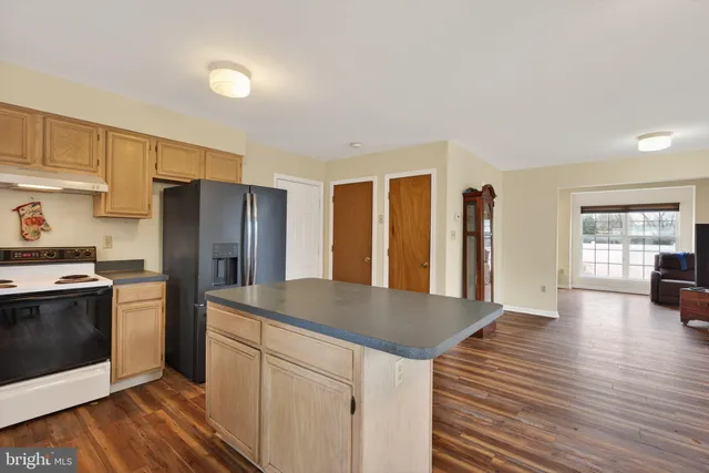 a kitchen with stainless steel appliances a refrigerator and a stove top oven