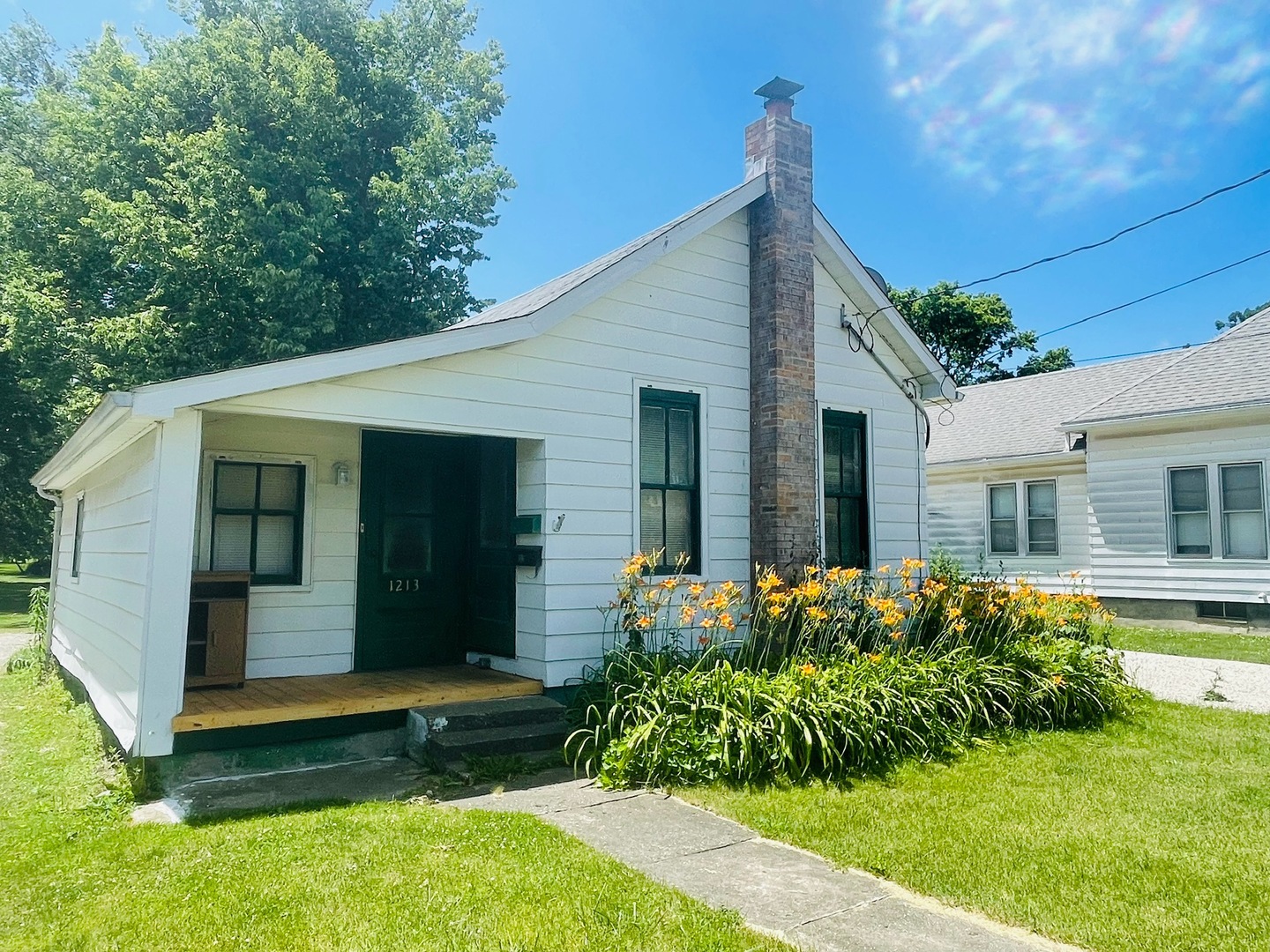 1213 East Main Street Streator, IL 61364 - Photo 3 of 18 a front view of a house with garden