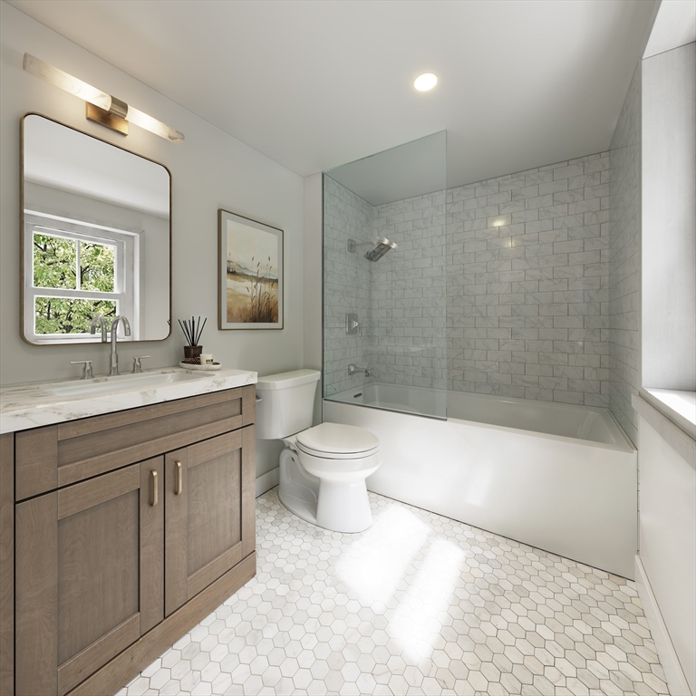 257 R Market Street, Unit 1 Boston, MA 02135 - Photo 8 of 9 a bathroom with a double vanity sink toilet and shower