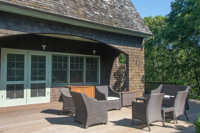 a view of a patio with table and chairs and wooden floor