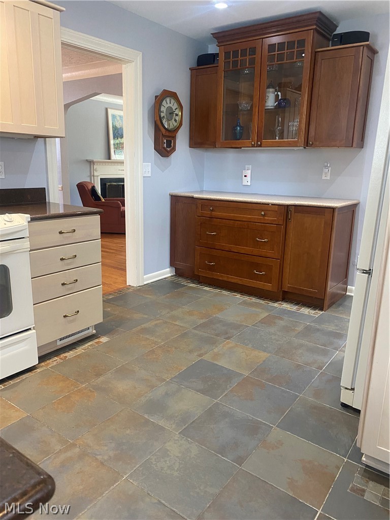 2460 Traymore Road Cleveland, OH 44118 - Photo 4 of 18 Kraftmaid Cherry cabinets, porcelain tile, and recessed lighting.