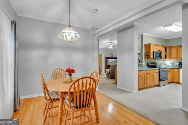 a view of a dining room with furniture kitchen and chandelier