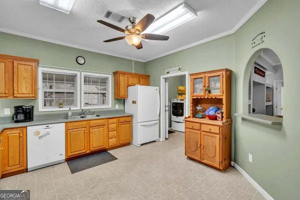 a kitchen with stainless steel appliances granite countertop a stove and a refrigerator