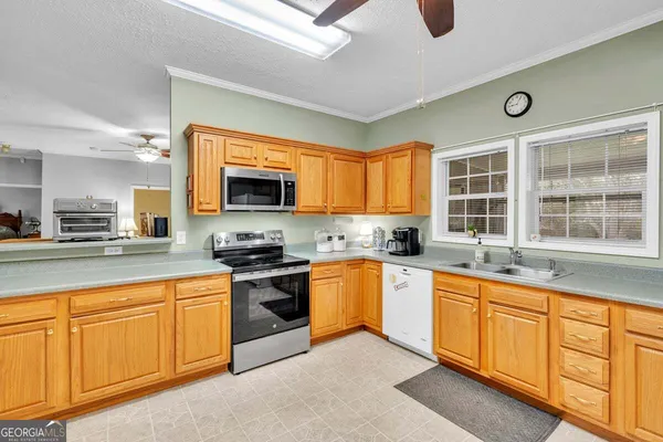 a kitchen with stainless steel appliances granite countertop a stove and a sink