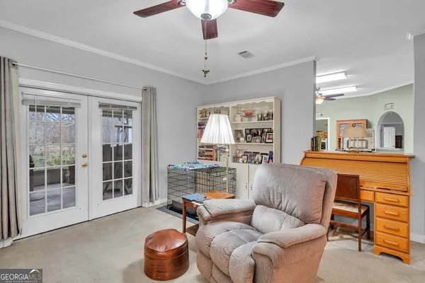 a bedroom with a bed couch and a view of kitchen