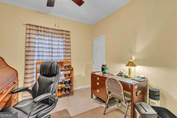 a bed sitting in a bedroom next to a window