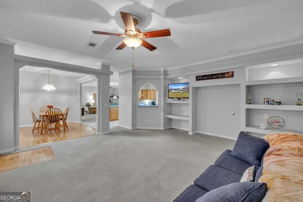 a living room with furniture and a chandelier