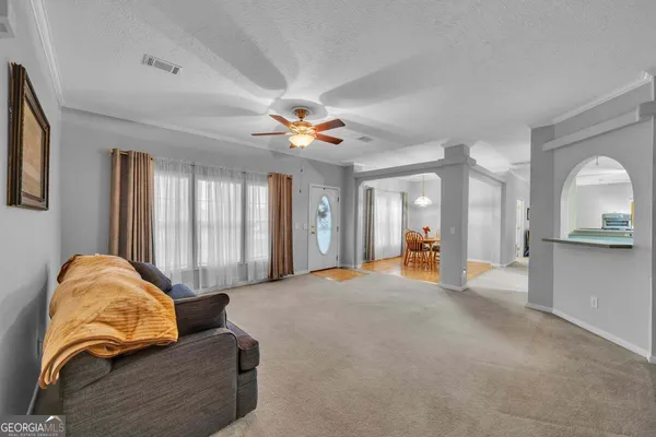 a living room with furniture and a chandelier
