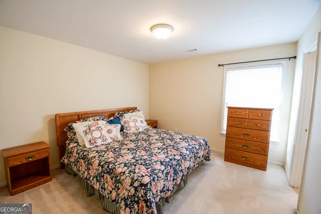 a bed sitting in a bedroom next to a window