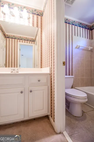 a bathroom with a toilet a sink and a mirror