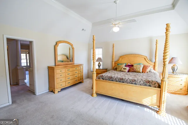a bedroom with bed and a chandelier