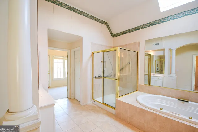 a spacious bathroom with a granite countertop sink a mirror and a shower