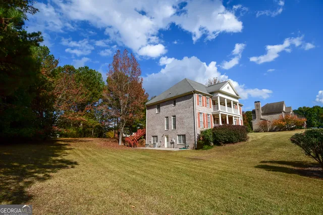 a view of a house with backyard and tree s