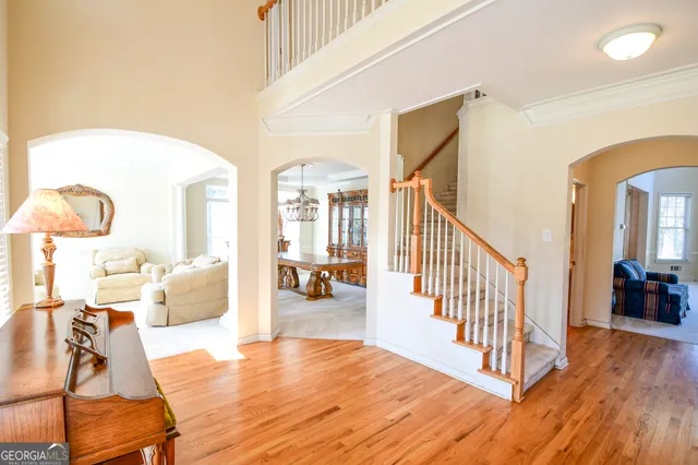 a view of a livingroom with furniture wooden floor and windows
