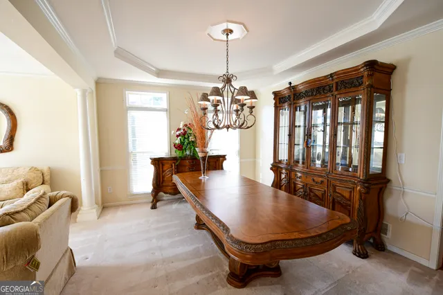 a room with table chairs and windows