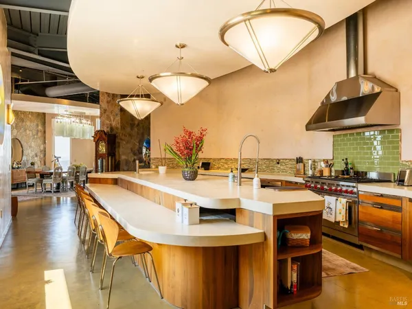 a large kitchen with a table and chairs