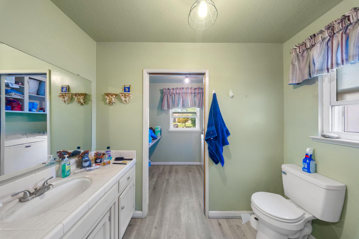 2779 Story Avenue Merced, CA 95340 - Photo 13 of 27 a bathroom with a sink vanity mirror and toilet