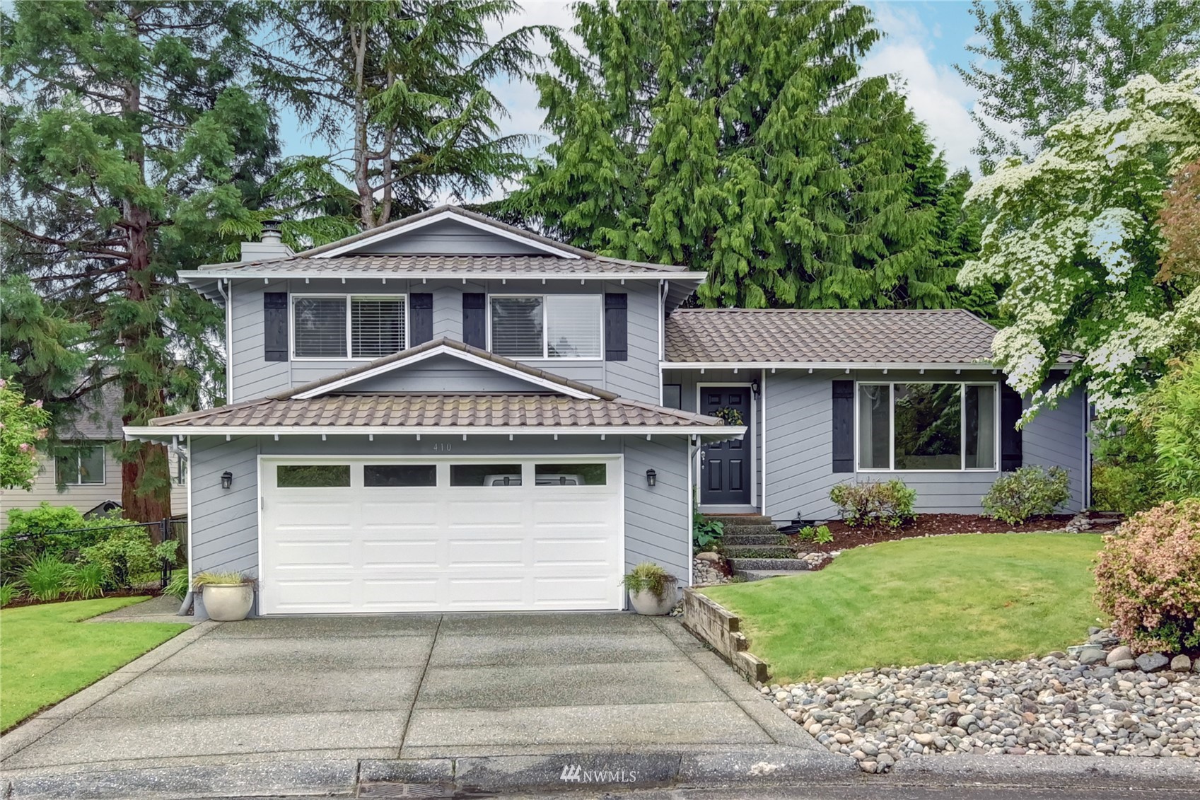 410 169th Street Southeast Bothell, WA 98012 - Photo 3 of 36 a front view of a house with a yard and garage