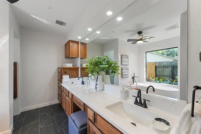 a kitchen with kitchen island a sink and a refrigerator