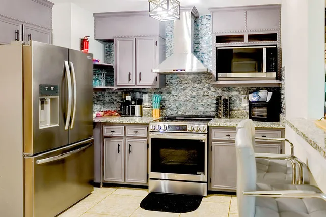 a bedroom with a large bed and a chandelier