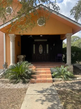a front view of a house with garden
